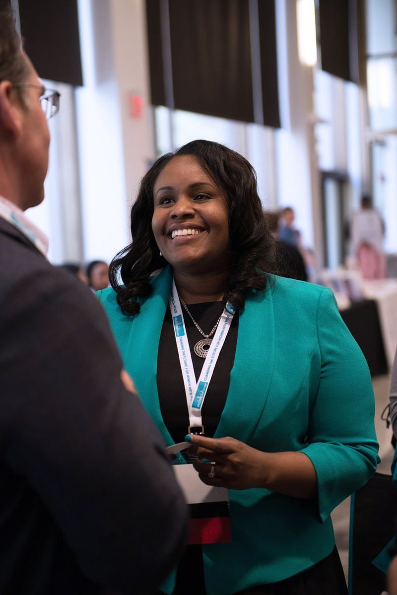 Sasha Ottey (right) talks with a participant at a PCOS Awareness Symposium in Philadelphia. She is founder and executive director of the nonprofit PCOS Challenge: National Polycystic Ovary Syndrome Association. CONTRIBUTED
