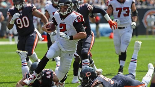 Matt Ryan of the Falcons runs for a first down against the Bears during the season-opening game Sunday at Chicago's Soldier Field.