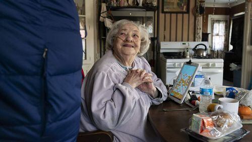 Rita Scanlon, 92, talks to a Meals on Wheels driver at her home in Rhode Island. A handful of states are gearing up to provide similar meals through Medicaid for people with diabetes, congestive heart disease and other chronic illnesses.
David Goldman The Associated Press