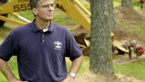Cobb Medical Examiner Brian Frist is shown at the scene of a July 2001 exhumation in this file photo.