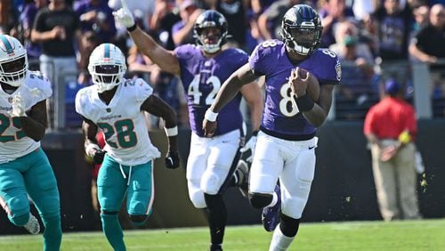 Baltimore Ravens quarterback Lamar Jackson, right, runs for a 79-yard touchdown against the Miami Dolphins on Sept. 18, 2022, at M&T Bank Stadium in Baltimore. (Kenneth K. Lam/The Baltimore Sun/TNS)