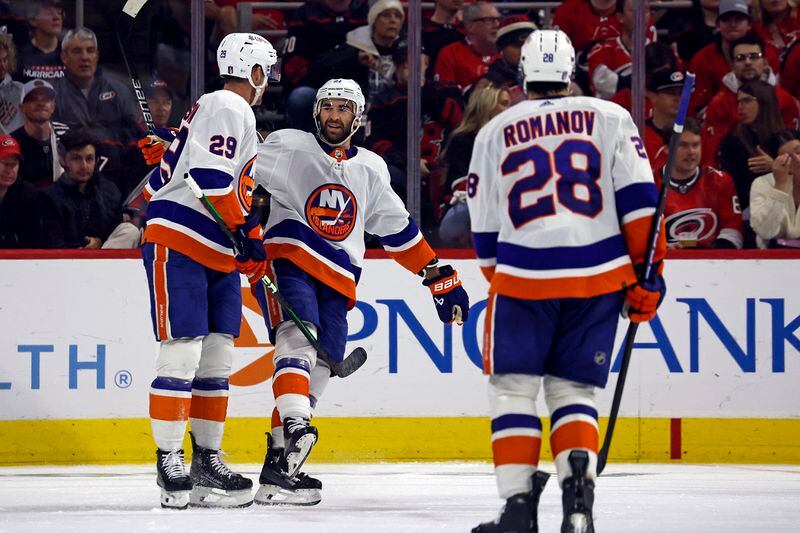 New York Islanders' Kyle Palmieri (21) congratulates Brock Nelson (29) on his goal during the second period in Game 5 of an NHL hockey Stanley Cup first-round playoff series against the Carolina Hurricanes in Raleigh, N.C., Tuesday, April 30, 2024. (AP Photo/Karl B DeBlaker)