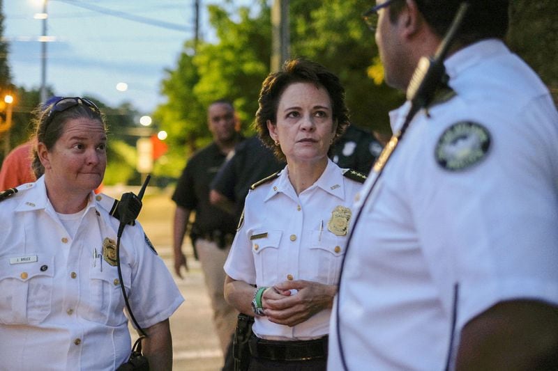 Then-Atlanta Police Chief Erika Shields huddles with officers on Briarcliff Road in Atlanta as protesters marched through Virginia Highlands past curfew on June 5. BEN GRAY FOR THE ATLANTA JOURNAL CONSTITUTION