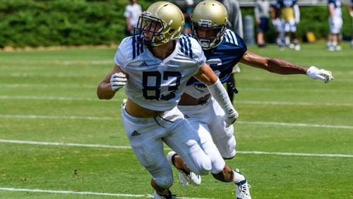 Georgia Tech wide receiver Brad Stewart looks for the ball as cornerback Lamont Simmons provides coverage in a practice on August 7, 2018. (Danny Karnik/Georgia Tech Athletics)