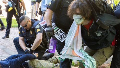 Police arrest pro-Palestinian protesters who set up an encampment at the Emory campus in Atlanta on Thursday, April 25, 2024. (Arvin Temkar / AJC)