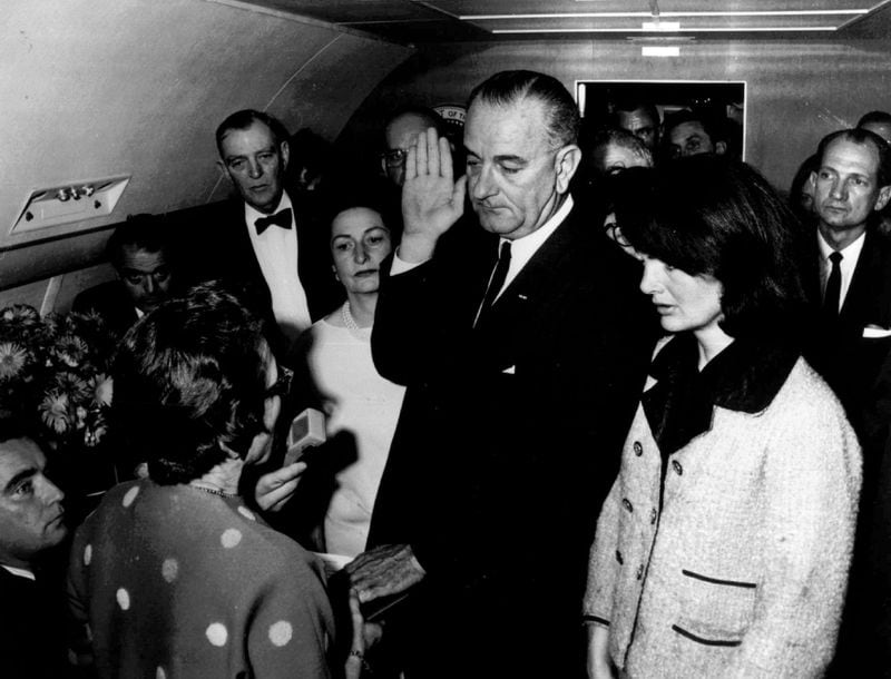 Lyndon B. Johnson is sworn in as President of the United States of America in the cabin of the presidential plane as Mrs. Jacqueline Kennedy stands at his side on Nov. 22, 1963. (Cecil Stoughton / White House)