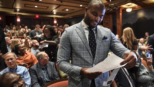 In this March 17, 2017, photo, Myron Rolle opens his "Match Day" letter that shows where he will continue his medical education and residency, in Tallahassee, Fla. Rolle was an All-American defensive back at Florida State but his bigger accomplishments have come off the field. He was a Rhodes Scholar and last month graduated from Florida State's College of Medicine. Rolle begins his neurosurgery residency next month at Harvard Medical School.  (Toni L. Sandys/The Washington Post via AP)
