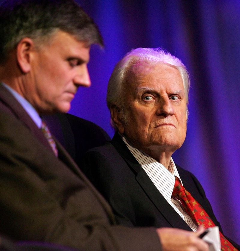In this  file photo, the Rev. Billy Graham, right, and his son Franklin Graham wait for the start of a service in New Orleans. (AP Photo/Bill Haber, File)