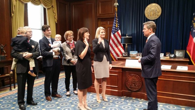 Candice Broce, pictured next to the U.S. flag, raises her right hand to take an oath after Gov. Brian Kemp was sworn in as governor in January 2019. Source: Broce's Facebook page