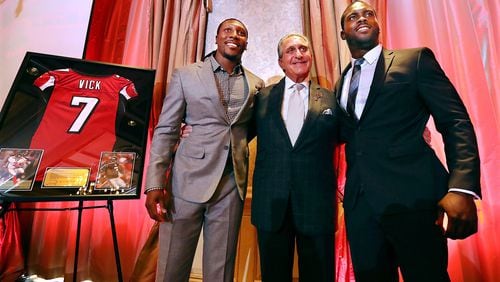 June 12, 2017, Atlanta: Atlanta Falcons owner Arthur Blank honors former Falcons quarterback Michael Vick (right) and wide receiver Roddy White as they officially retire from the NFL on Monday, June 12, 2017, in Atlanta. Curtis Compton/ccompton@ajc.com