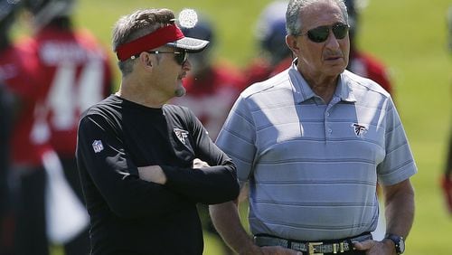 Atlanta Falcons owner Arthur Blank, right, talks with general manager Thomas Dimitroff during NFL minicamp football Thursday, June 15, 2017, in Flowery Branch, Ga. (AP Photo/John Bazemore)