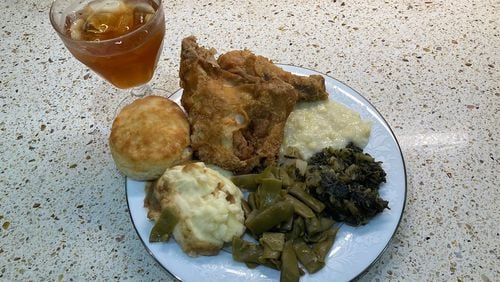 This re-creation of a typical Sunday dinner at Grandma King’s includes fried chicken, creamed corn, turnip greens, green beans, mashed potatoes, a biscuit and iced tea. (Bill King for The Atlanta Journal-Constitution)