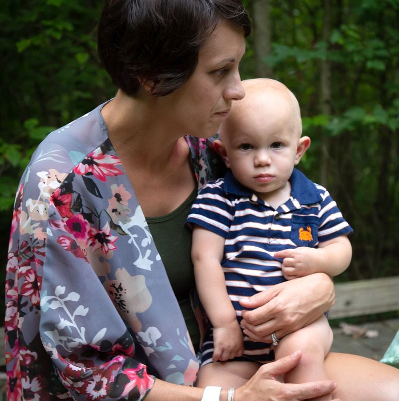 Angie Rush holds her son Carter while on a walk near her Marietta home on July 27, 2020.  STEVE SCHAEFER FOR THE