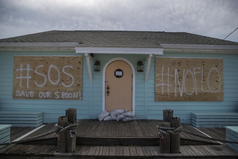 A boarded-up business with anti-storm messages in Nags Head, N.C., on Tuesday, Sept. 11, 2018. 
