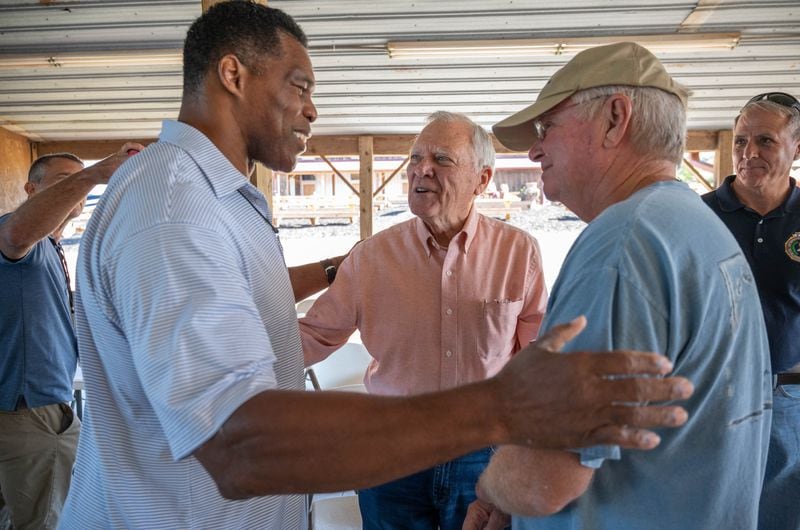  Republican Senate nominee Herschel Walker (left) greets former Gov. Nathan Deal (center) and Ron Hooper, chairman of Banks County Republican Party, after a roundtable with local farmers at Jaemor Farms in Alto on Tuesday, September 13, 2022.(Hyosub Shin / Hyosub.Shin@ajc.com)