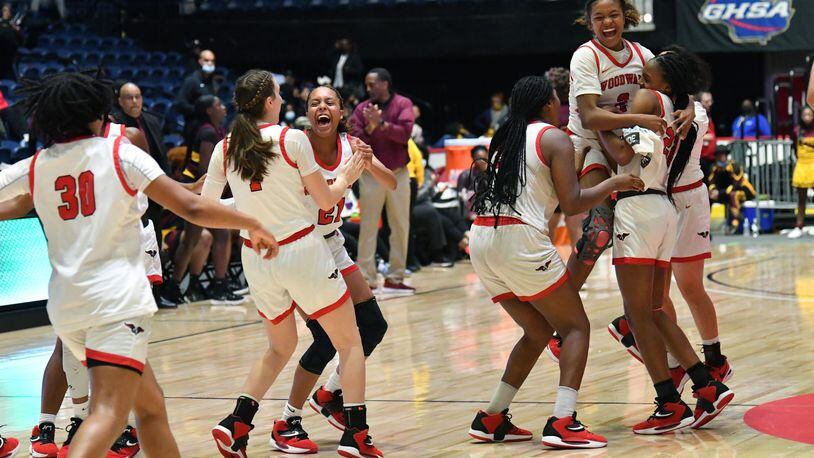 March 10, 2022 Macon - Woodward Academy players celebrate their victory over Forest Park during the 2022 GHSA State Basketball Class AAAAA Girls Championship game at the Macon Centreplex in Macon on Thursday, March 10, 2022. (Hyosub Shin / Hyosub.Shin@ajc.com)
