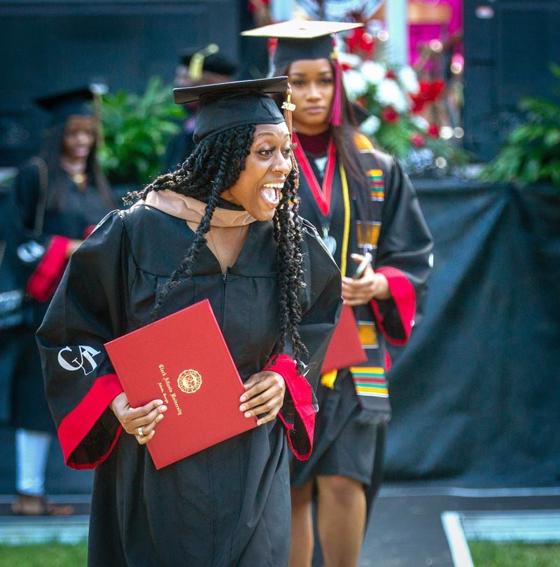 A 2020 Clark Atlanta University graduate reacts after getting her diploma Saturday at the Harkness Hall Quadrangle in Atlanta on May 15, 2021. The 2020 ceremony was postponed because of the COVID-19 pandemic. (Steve Schaefer for The Atlanta Journal-Constitution)