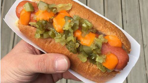 Joshua Hopkins of Empire State South shows off his hot dog from last year's Helpful Hotdog initiative. / @helpfulhotdog Instagram