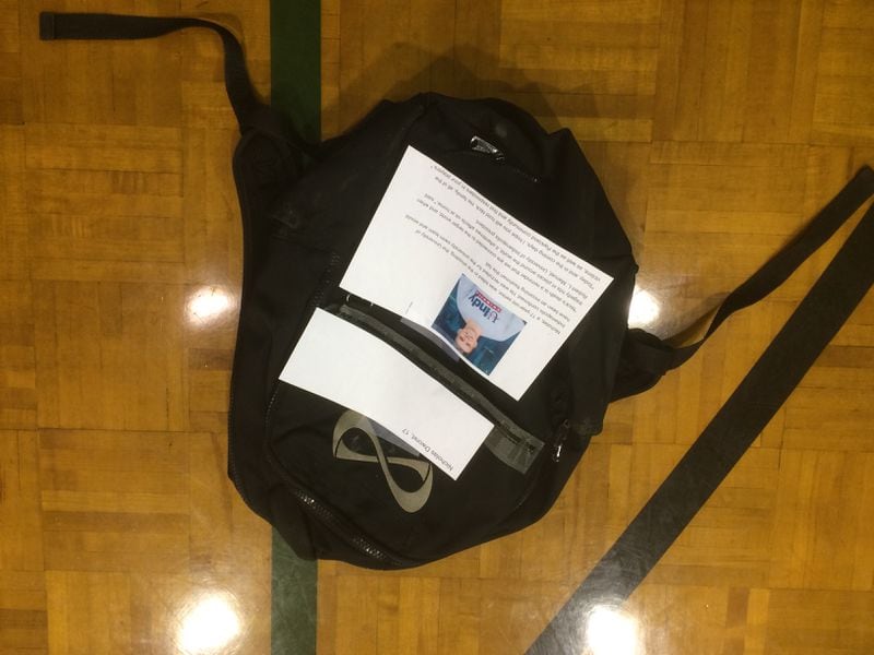 Seventeen book bags were laid out in the floor of Mundy's Mill Middle School gym to represent the victims of Parkland, Florida. (Mitchell Northam/AJC)