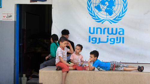 FILE - Palestinian children who fled with their parents from their houses in the Palestinian refugee camp of Ein el-Hilweh, gather in the backyard of an UNRWA school, in Sidon, Lebanon, Sept. 12, 2023. An independent review released Monday, April 22, 2024, of the neutrality of UNRWA, the U.N. agency helping Palestinian refugees, has found that Israel never expressed concern about anyone on the staff lists it has received annually since 2011. The review was carried out after Israel alleged that a dozen employees of the agency had participated in Hamas’ Oct. 7 attacks. (AP Photo/Mohammed Zaatari, File)