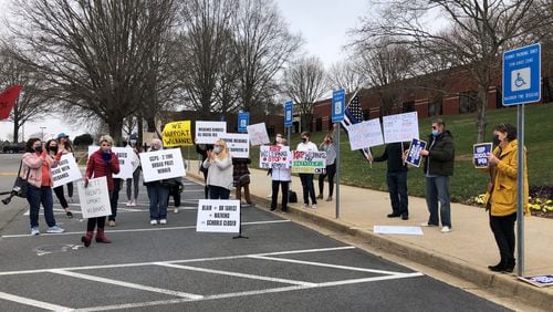 Parents gathered outside Gwinnett school district headquarters to show their support for Superintendent J. Alvin Wilbanks because they believe the school board plans next week to buy out his contract. (Alia Malik / AJC)