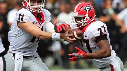Georgia quarterback Jake Fromm hands off to tailback Nick Chubb for a touchdown run to take a 21-0 lead over Vanderbilt during the second quarter Saturday in Nashville. (Curtis Compton/ccompton@ajc.com)