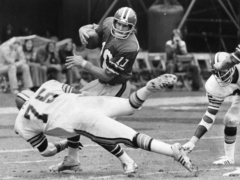 Falcons quarterback Steve Bartkowski dodges the New Orleans Saints' pass rush, October 1975. Charles Pugh Jr./AJC file