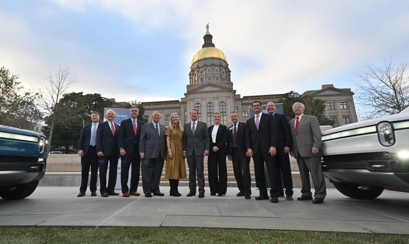 December 16, 2021 Atlanta - Governor Brian Kemp (center) and Georgia lawmakers pose with Helen Russell, Chief People Officer at Rivian, during a press conference at Liberty Plaza across from the Georgia State Capitol in Atlanta on Thursday, December 16, 2021. Electric vehicle maker Rivian on Thursday confirmed its plans to build a $5 billion assembly plant and battery factory in Georgia, which Gov. Brian Kemp called Òthe largest single economic development project ever in this stateÕs history.Ó (Hyosub Shin / Hyosub.Shin@ajc.com)