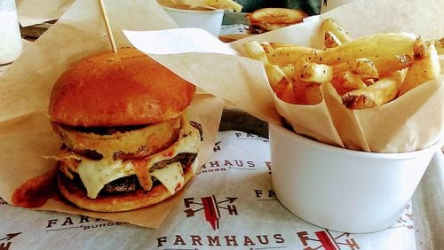 The Chili Cheese burger with a buttermilk battered onion ring on an artisan bun with a side of hand-cut Russet fries at Farmhaus Burger in downtown Augusta. CONTRIBUTED BY BLAKE GUTHRIE