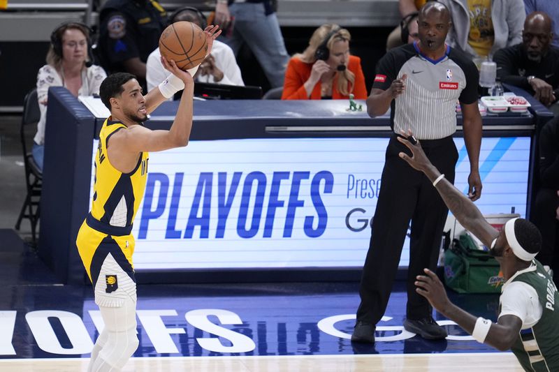 Indiana Pacers guard Tyrese Haliburton, left, shoots over Milwaukee Bucks forward Bobby Portis during the first half in Game 6 in an NBA basketball first-round playoff series, Thursday, May 2, 2024, in Indianapolis. (AP Photo/Michael Conroy)