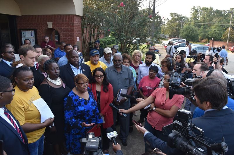 Voting rights advocates including Helen Butler with the Georgia Coalition for the People’s Agenda speak to members of the press outside the Randolph County Government Center after the county’s Board of Elections defeated a proposal to close seven rural voting locations on Friday. HYOSUB SHIN / HSHIN@AJC.COM