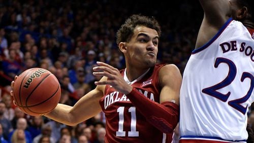 Trae Young of the Oklahoma Sooners looks to pass the ball against Silvio De Sousa of the Kansas Jayhawks in the second half at Allen Fieldhouse on February 19, 2018 in Lawrence, Kansas. (Photo by Ed Zurga/Getty Images)