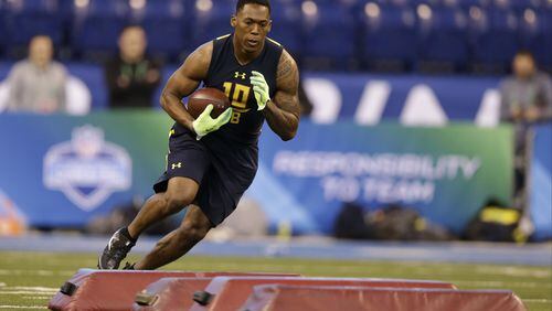 Clemson running back Wayne Gallman runs a drill at the NFL football scouting combine in Indianapolis, Friday, March 3, 2017. (AP Photo/Michael Conroy)