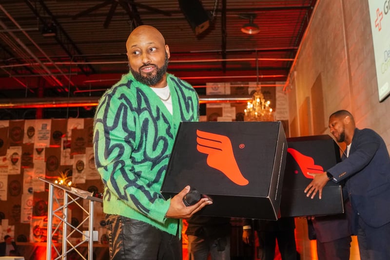 Jahi Rawlings of Finish First Marketing Agency holds a box of special-edition sneakers at the 404 Day scholarship gala on April 3, 2024, in Atlanta.