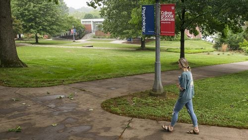 A woman walks the campus at the University of West Georgia in Carrollton. The plot of land on the the upper half of this image is where recent archaeological tests suggest slaves from a former plantation might be buried. If true, UWG will be added to a long list of colleges and communities challenged with questions on how to deal with newly discovered remains of former slaves and Reconstruction-era African Americans. (ALYSSA POINTER/ALYSSA.POINTER@AJC.COM)