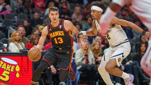 Hawks guard Bogdan Bogdanovic (13) drives against the Denver Nuggets during Monday's game at State Farm Arena.