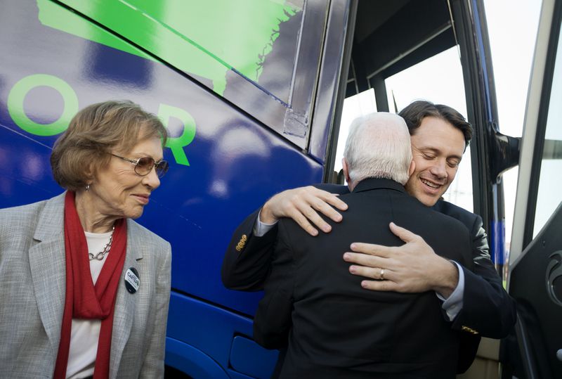 Jason Carter, right, embraces his grandfather, former President Jimmy Carter, as former first lady Rosalynn Carter, left, looks on in Columbus, Ga., in 2014. (AP Photo/David Goldman)