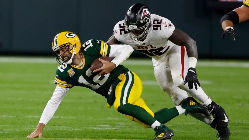 Packers QB Aaron Rodgers is sacked by Charles Harris of the Falcons during the second half.