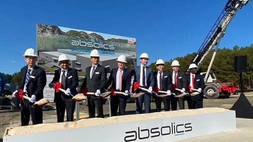 Absolics, which is building a factory in Covington that will craft vital components for making semiconductors, will receive grant funding from a federal program designed to boost domestic computer chip manufacturing. U.S. Sen. Jon Ossoff, (fourth from right), D-Ga., said incentives were fueled by the bipartisan CHIPS and Science Act,