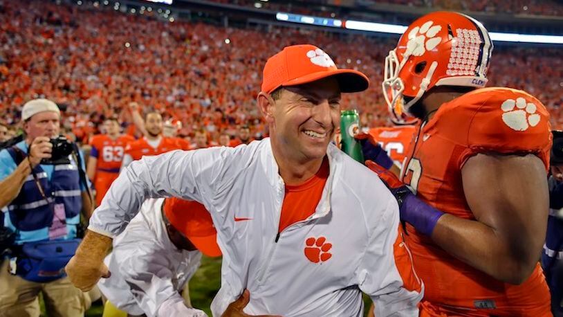 FILE - In this Nov. 7, 2015, file photo, Clemson head coach Dabo Swinney celebrates after their 23-17 win over Florida State in an NCAA college football game in Clemson, S.C. Swinney has been named the AP coach of the year, Monday, Dec. 21, after leading the Tigers to an undefeated season and spot in the College Football Playoffs. (AP Photo/Richard Shiro, File)