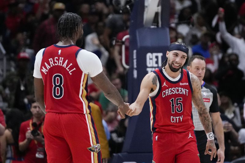 New Orleans Pelicans guard Jose Alvarado (15) celebrates with forward Naji Marshall (8) in the second half of an NBA basketball play-in tournament game against the Sacramento Kings in New Orleans, Friday, April 19, 2024. The Pelicans won 105-98. (AP Photo/Gerald Herbert)