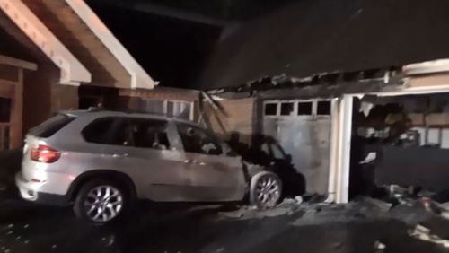 A fire that started in this SUV spread to the house early Friday in Gwinnett County.