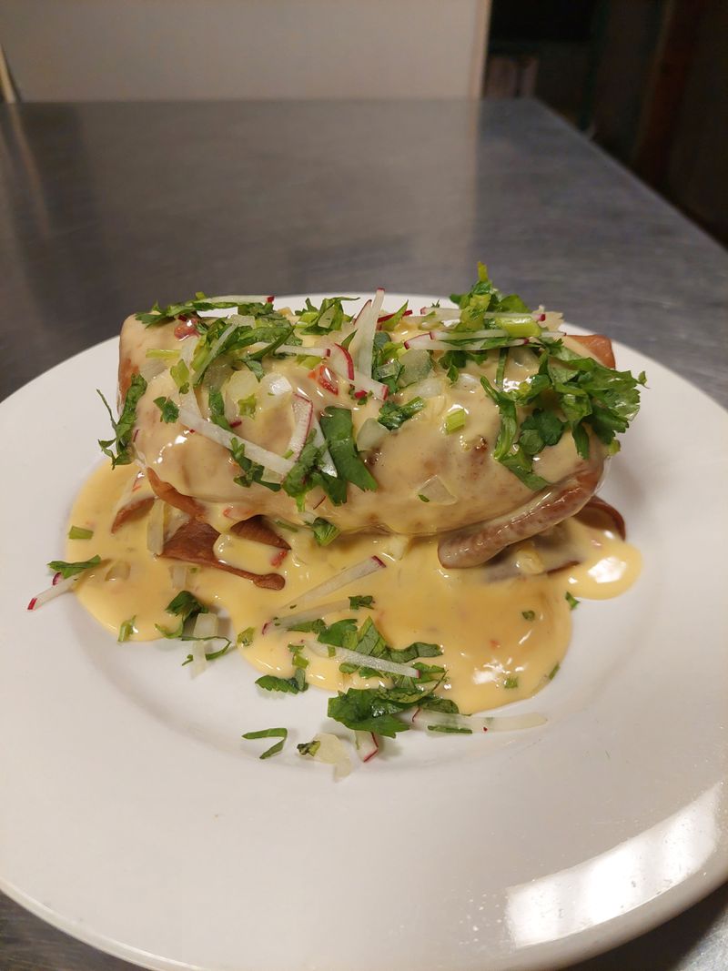 The Southern Chimichanga from the menu of A Golden Apple pop-up includes collard greens and pimento cheese sauce. / Courtesy of Andrew McGill