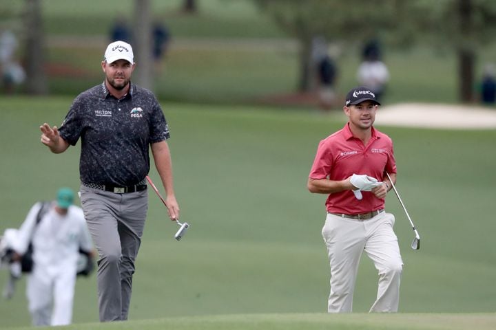 April 10, 2021, Augusta: Marc Leishman, left, and Brian Harman walk up to the eighteenth green during the third round of the Masters at Augusta National Golf Club on Saturday, April 10, 2021, in Augusta. Curtis Compton/ccompton@ajc.com