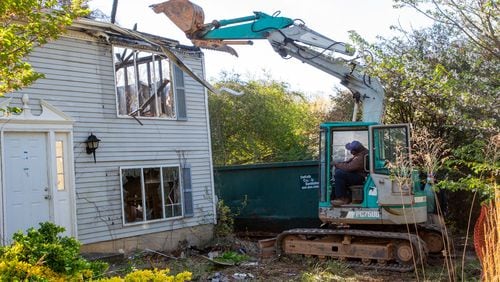 DeKalb County officials demolish a home as part of their efforts to address blight in Stone Mountain on Friday, April 1, 2022. STEVE SCHAEFER FOR THE ATLANTA JOURNAL-CONSTITUTION