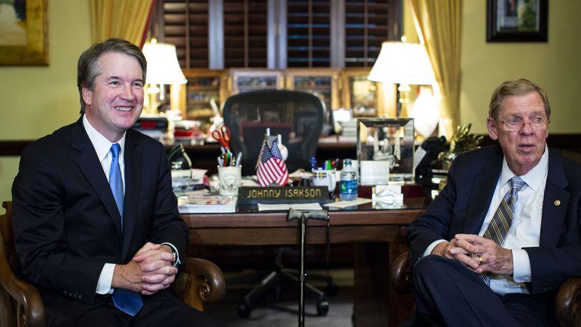 Judge Brett Kavanaugh, left, President Donald Trump’s Supreme Court nominee, meets with Republican U.S. Sen. Johnny Isakson of Georgia in July. (Al Drago/The New York Times)
