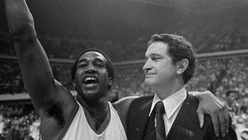 Marquette's Butch Lee (left) and his coach Al McGuire smile after the Marquette beat UNCC 51-49 in the NCAA semifinals on this March 26, 1977 in Atlanta.