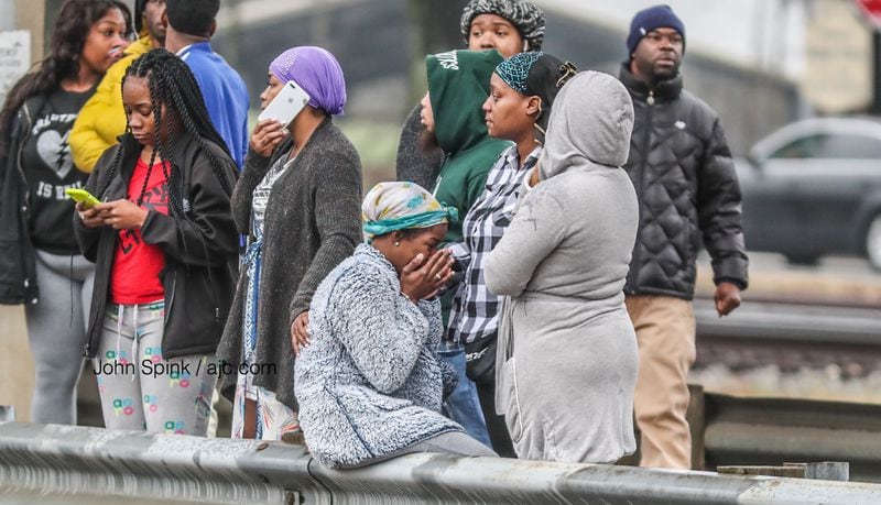 A large number of grief-stricken people were at the scene of the deadly double shooting. JOHN SPINK / JSPINK@AJC.COM