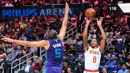 The Hawks’ Damion Lee scores on a corner 3-pointer over the Hornets’ Nicolas Batum during Thursday’s game at Philips Arena.