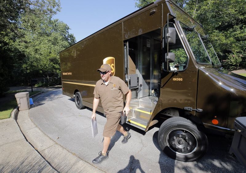 Driver Dan Partyka delivers an overnight package last year. As more people buy more goods online, the rapid and unrelenting expansion of e-commerce is causing real challenges for UPS. It costs more to deliver items to individual doorsteps instead of delivering a whole pallet full of goods to stores. BOB ANDRES /BANDRES@AJC.COM